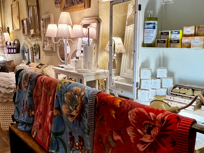 Tasses et cuillères rouges avec motifs floraux jaunes et blancs, présentées dans des boîtes rouges décorées.